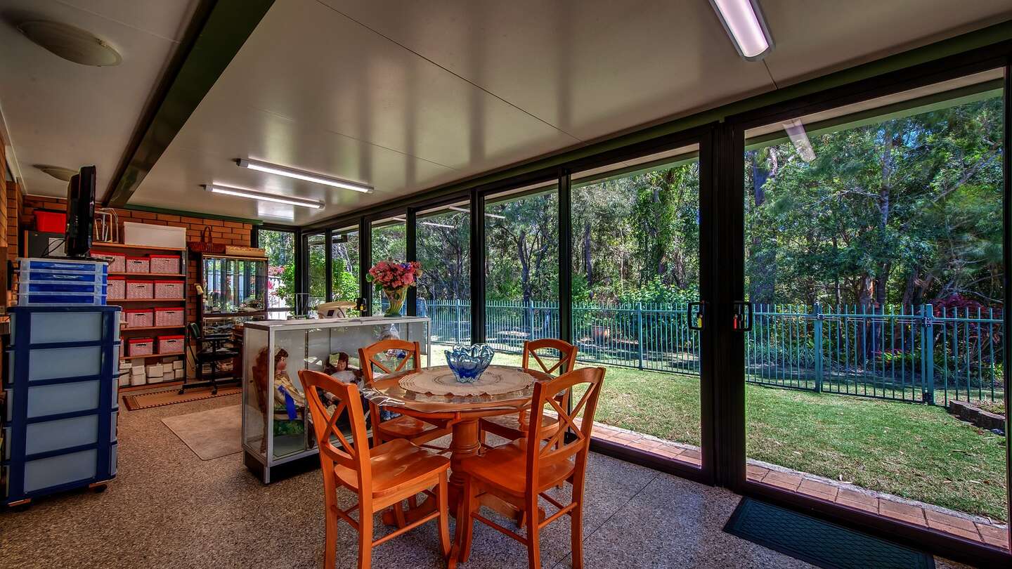 Mesh Sunroom with table setting in the interior. 
